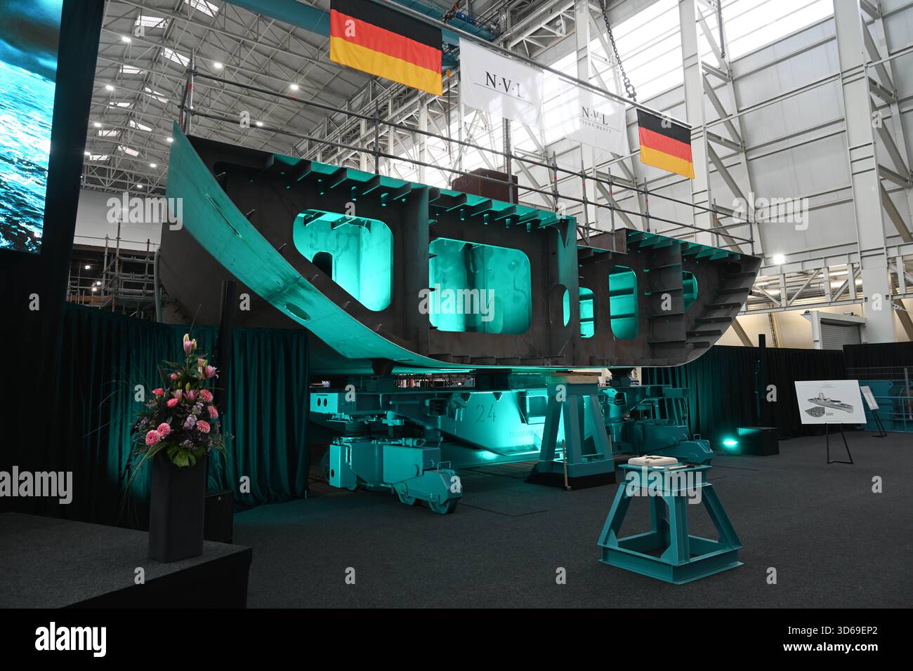 Wolgast, Germany. 19th Nov, 2025. Keel laying of the second fleet service boat in the shipyard hall of the Peene shipyard. The contract for the construction was awarded to the Bremen-based Naval Vessels Lürssen Group (NVL). Work on the ships is to be carried out at several shipyards in northern Germany. Credit: Stefan Sauer/dpa/Alamy Live News Stock Photo