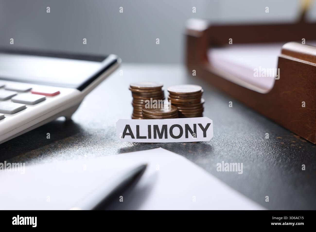 Paper note with word Alimony, coins, calculator, documents and pen on dark table, closeup Stock Photo