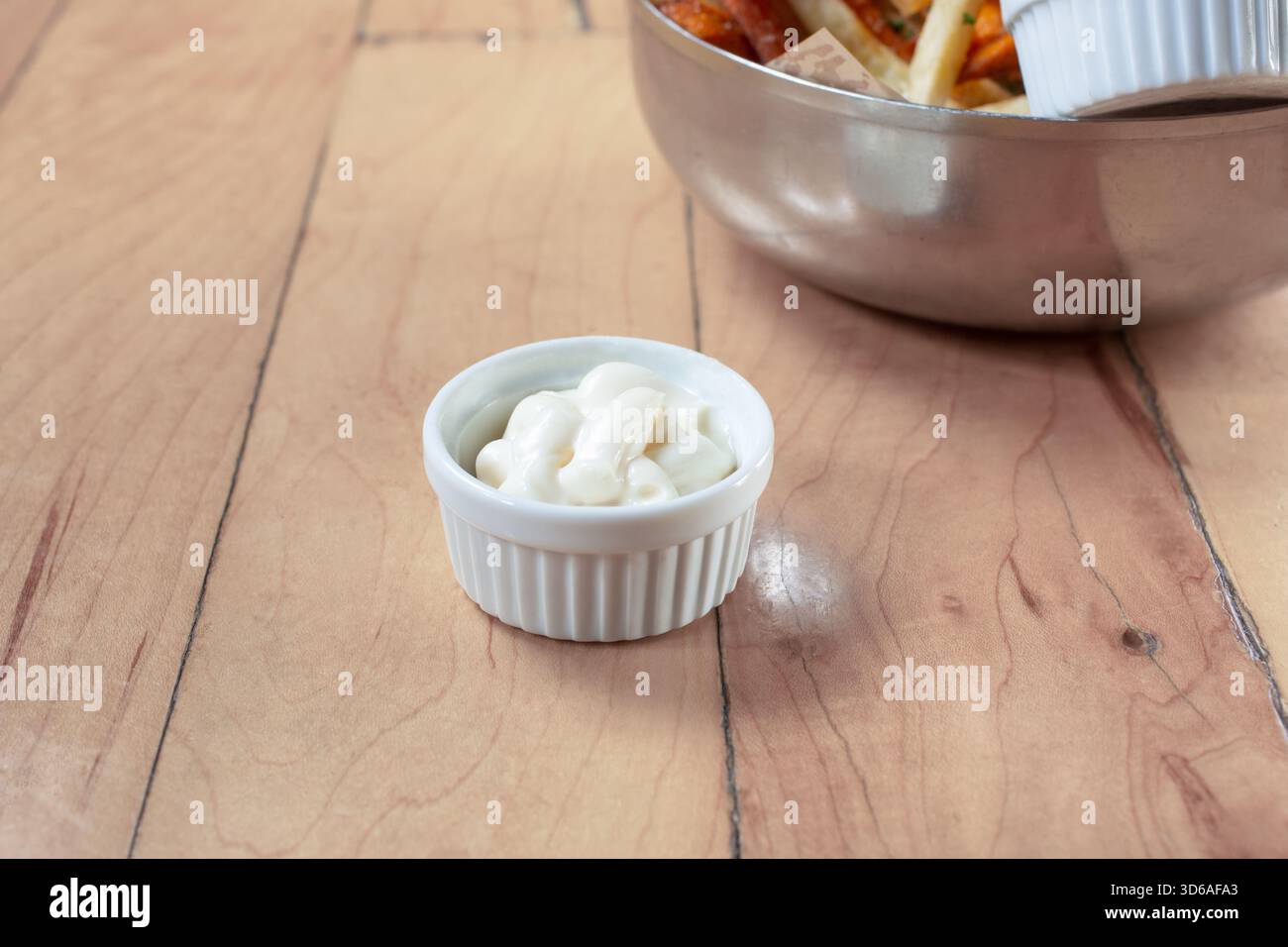 A view of a condiment cup of mayonnaise. Stock Photo