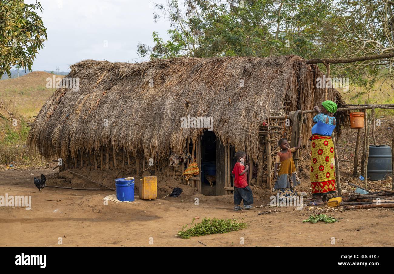 villagers-in-a-traditional-village-mud-huts-sadaani-tanzania-stock
