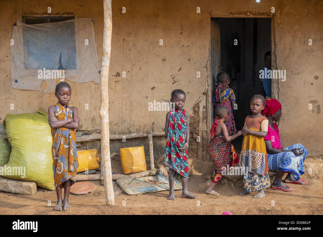 villagers-in-a-traditional-village-mud-huts-sadaani-tanzania-stock