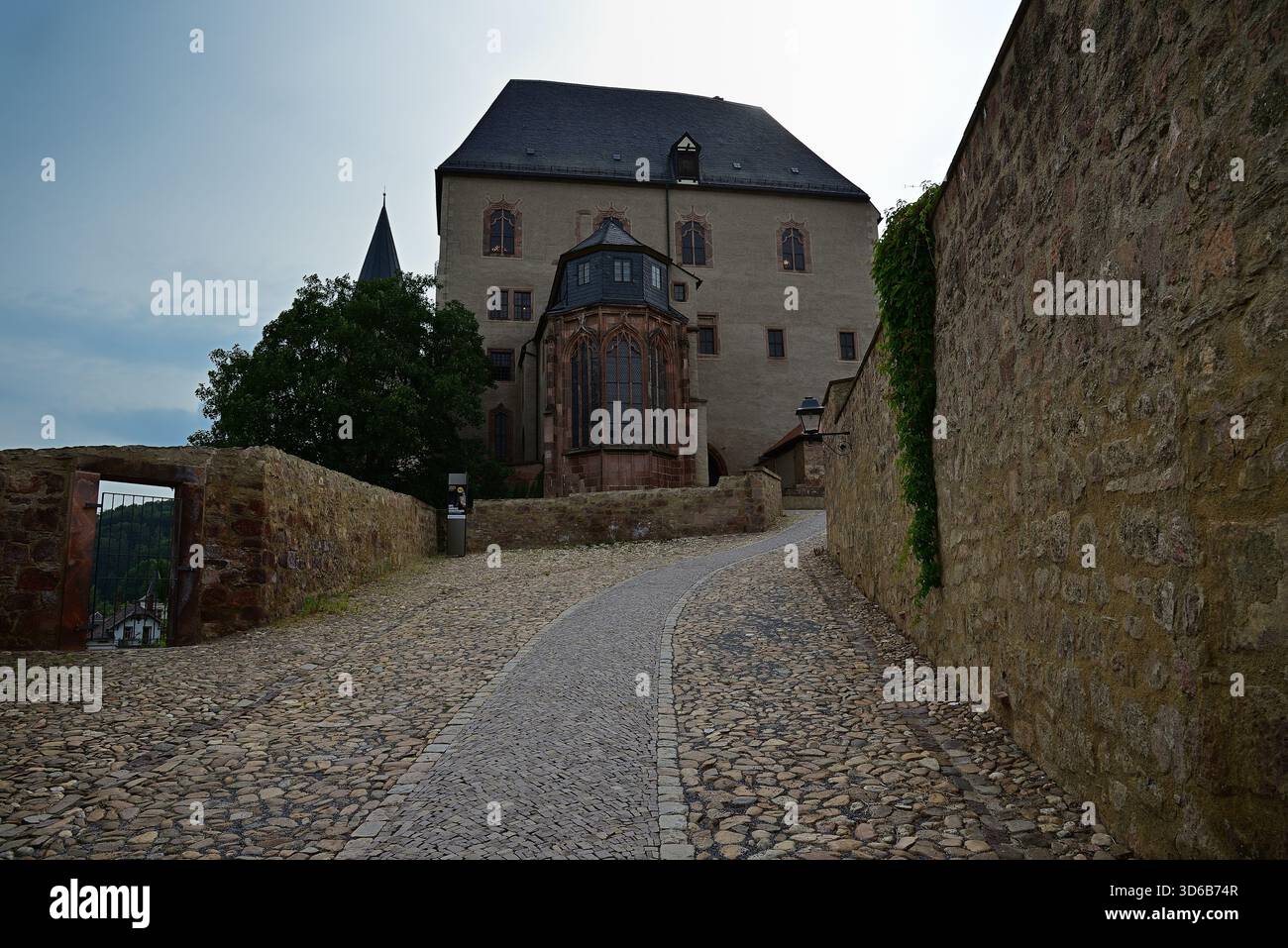 Historic building complex with cobblestone path and Gothic annex Stock ...