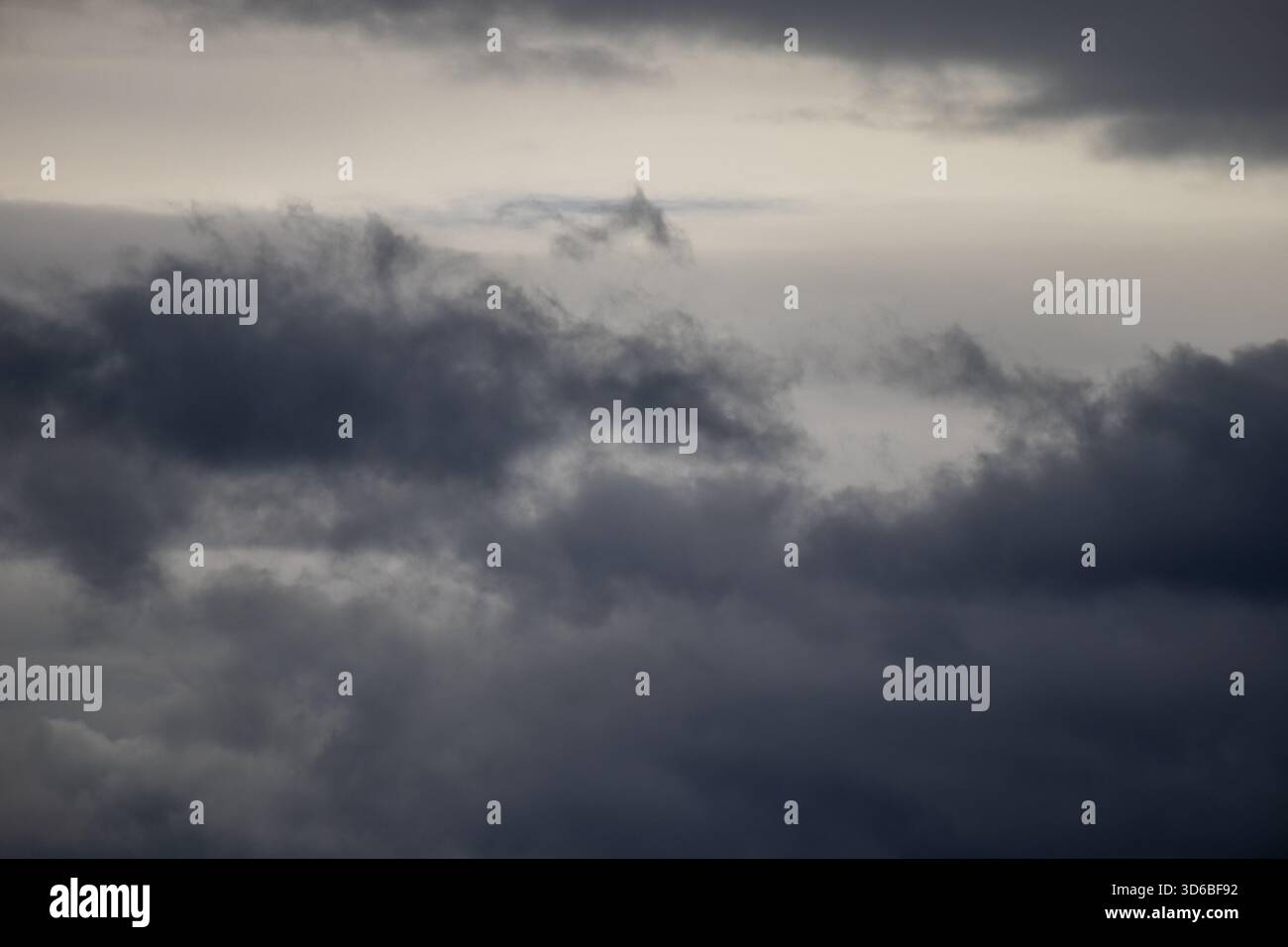 Dark storm clouds over a grey sky Stock Photo