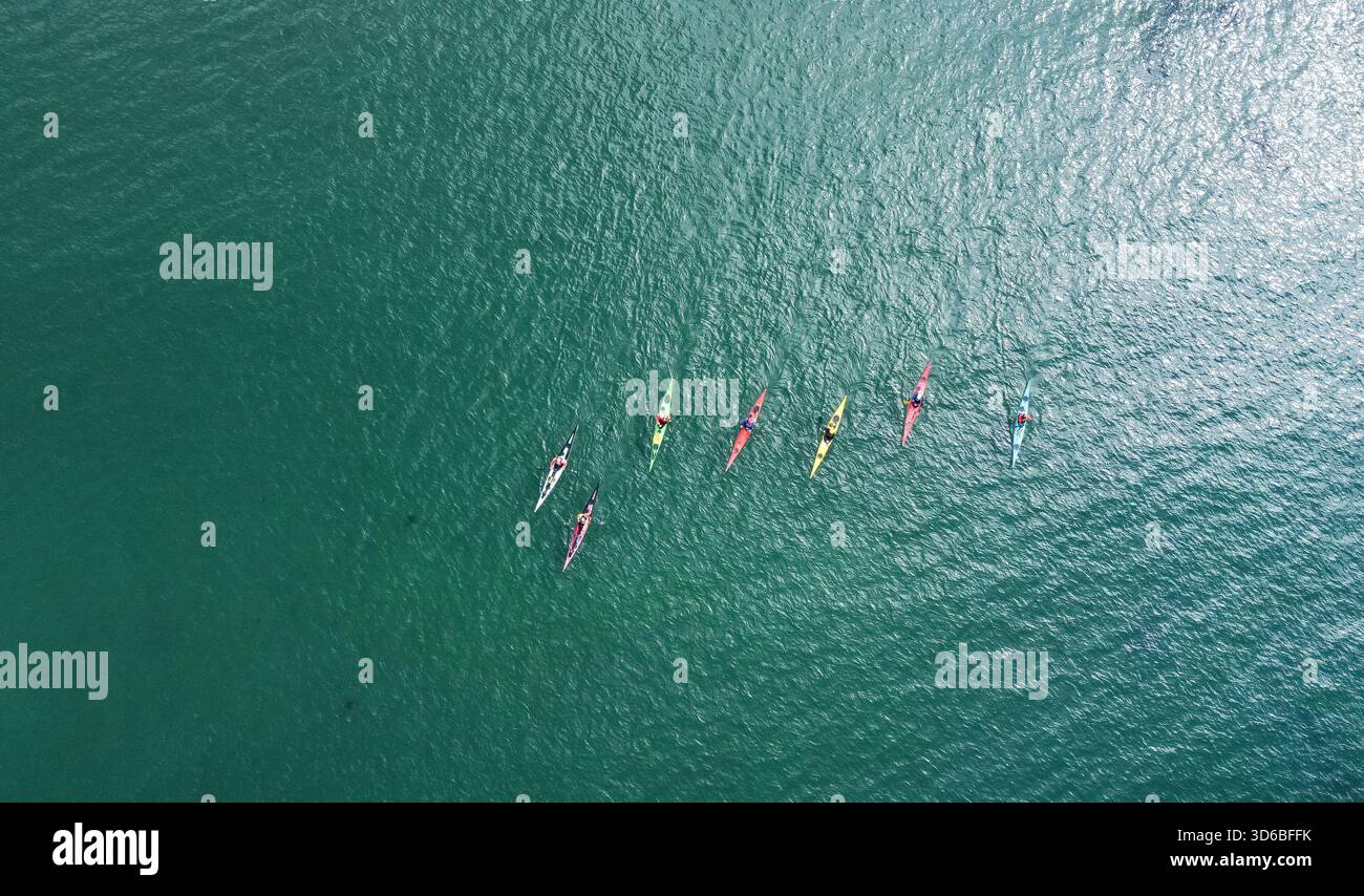 Aerial view of kayakers paddling across open water Stock Photo - Alamy