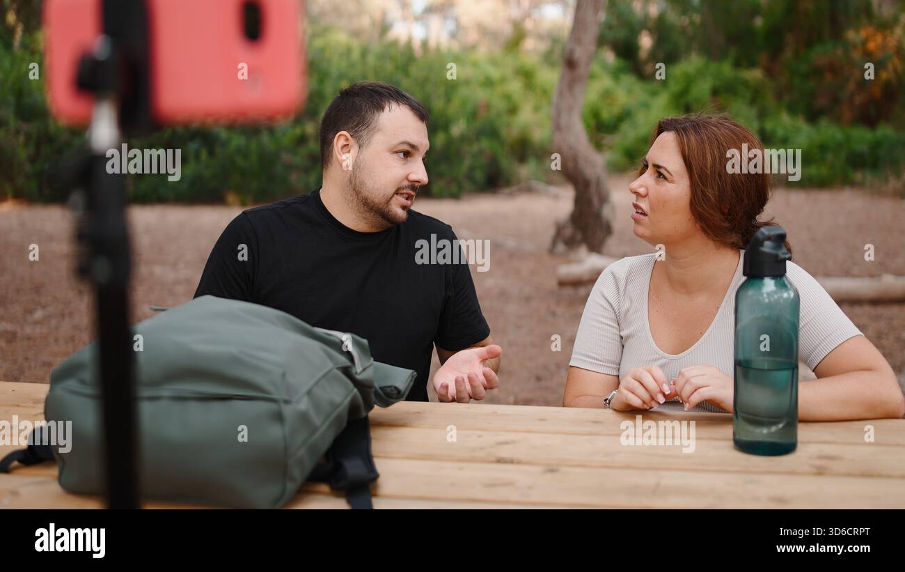 Influencers creating online content outdoors, having discussion for ...