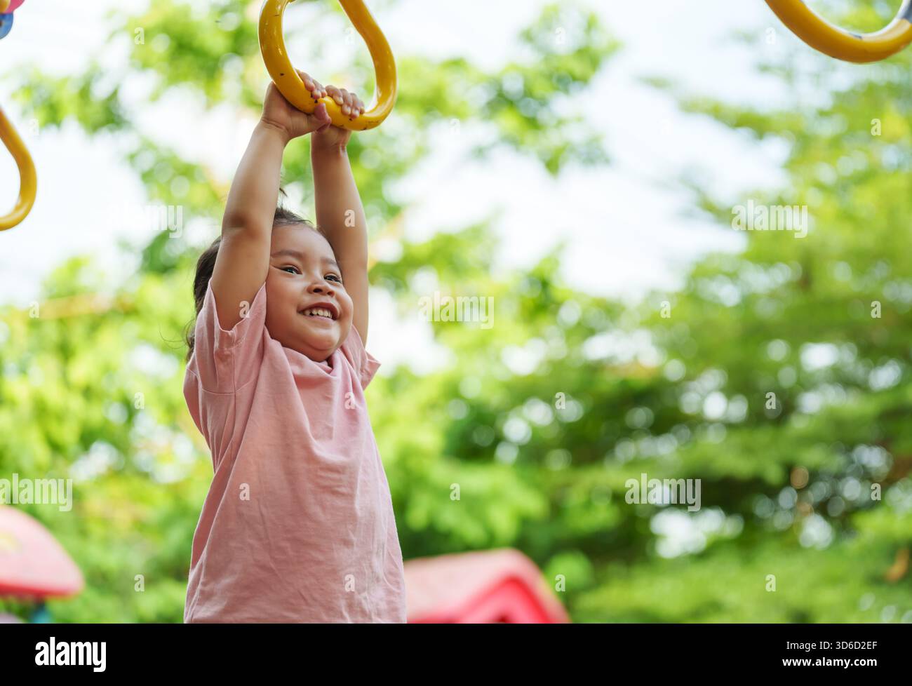 Kids Using Playground Rings toddler girl hanging on playground rings in the park Stock Photo - Alamy