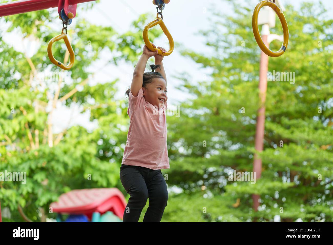 Kids Using Playground Rings toddler girl hanging on playground rings in the park Stock Photo - Alamy