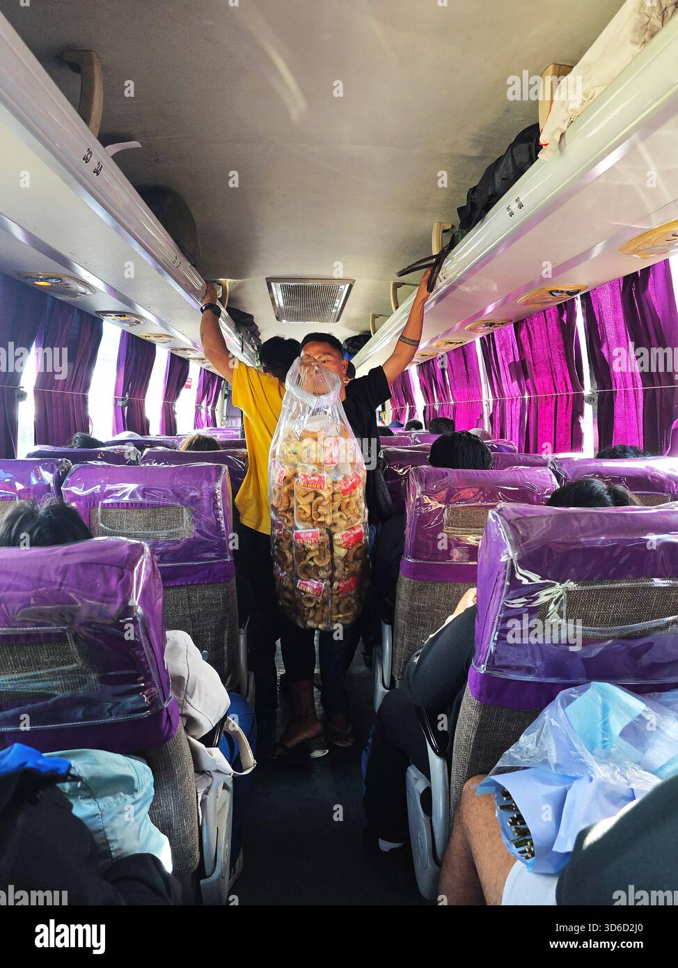 A Filipino man selling Chicharon Bagnet on a Coda Line bus in Luzon, Philippines. - Smartphone Captured Stock Image