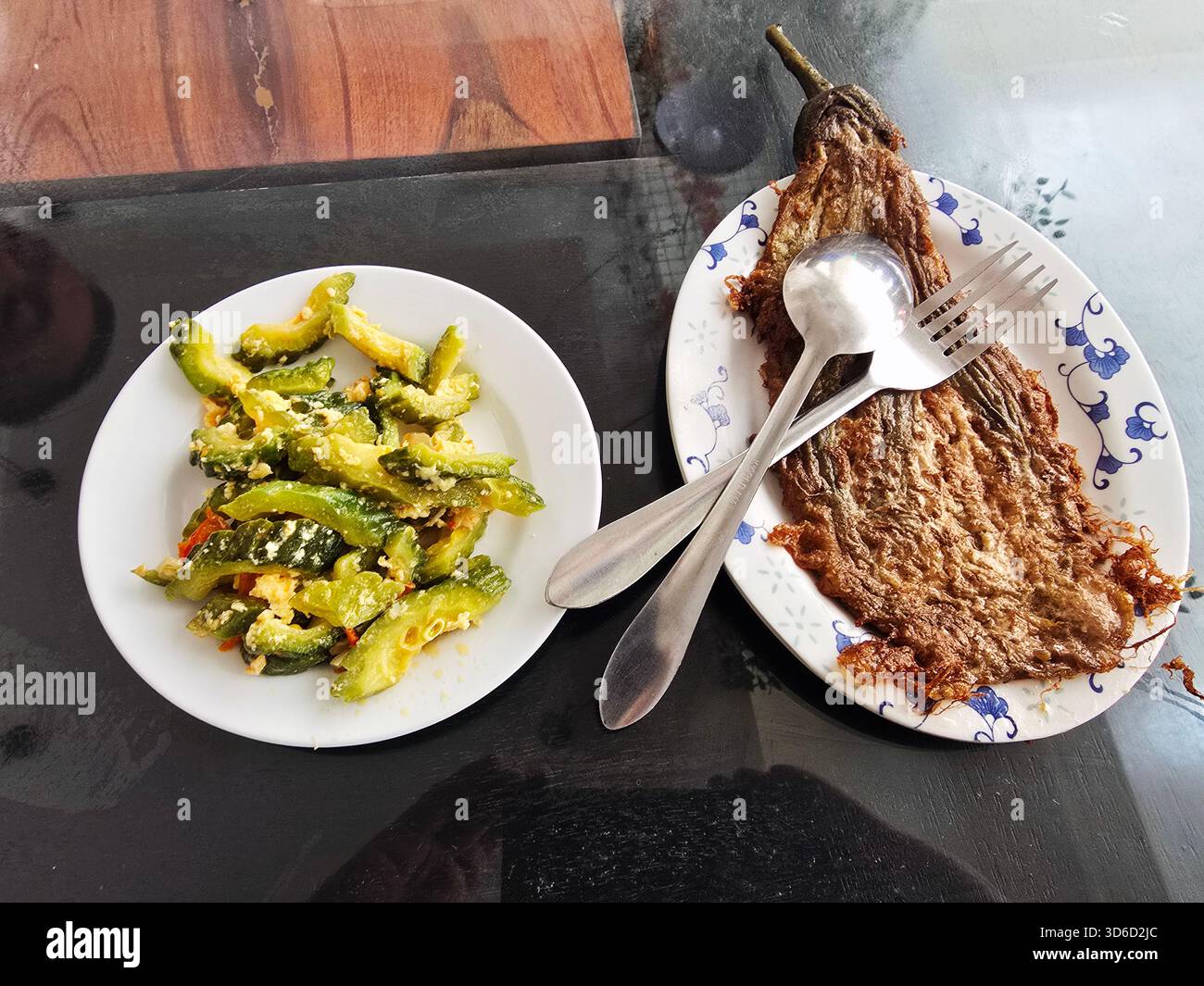 Filipino dishes - Tortang Talong and stir fried ampalaya ( Bitter Melon ) in Luzon, Philippines. - Smartphone Captured Stock Image