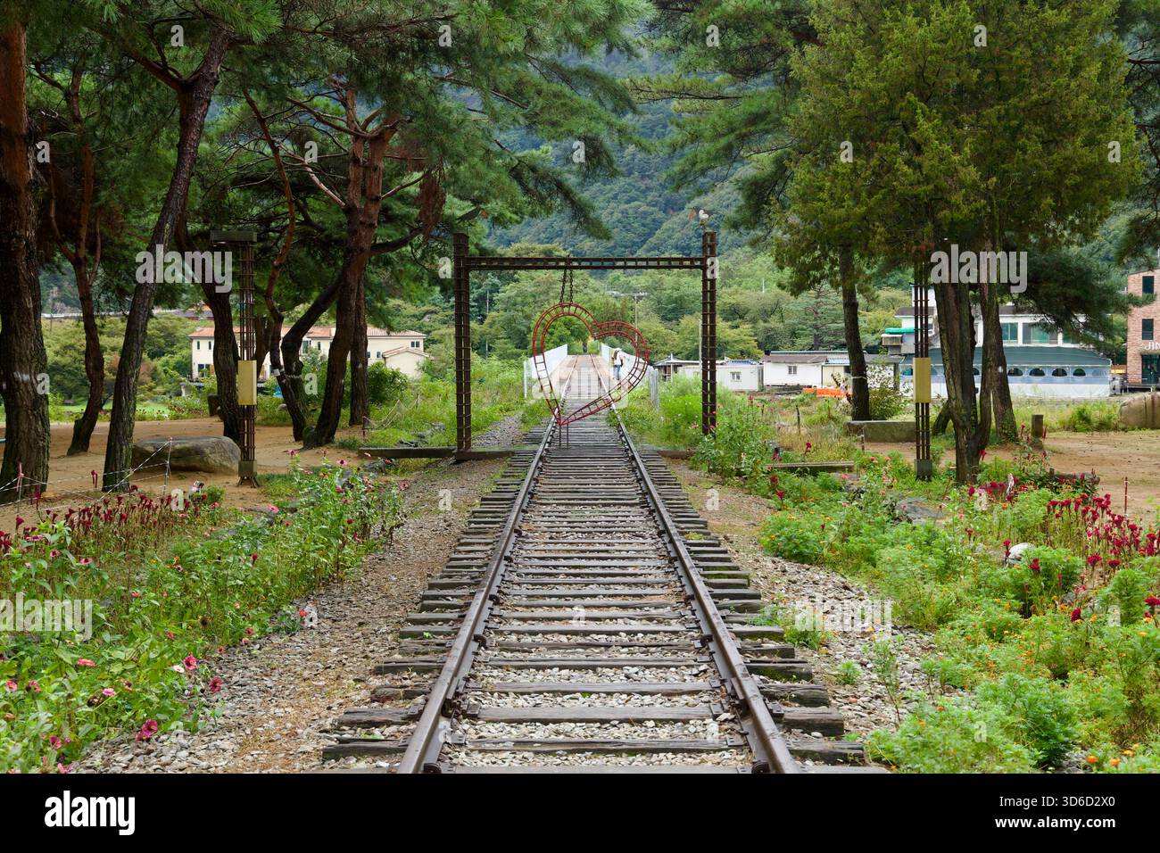 A heart‑shaped metal frame hangs over the disused Mungyeong Line tracks ...