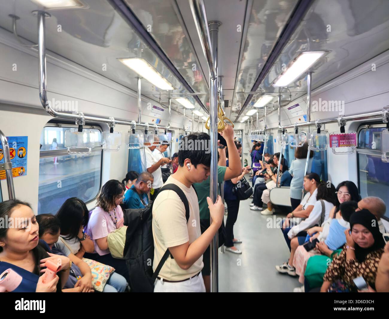 Passengers on the LRT 2 metro in Quezon City, Metro Manila, Philippines. - Smartphone Captured Stock Image