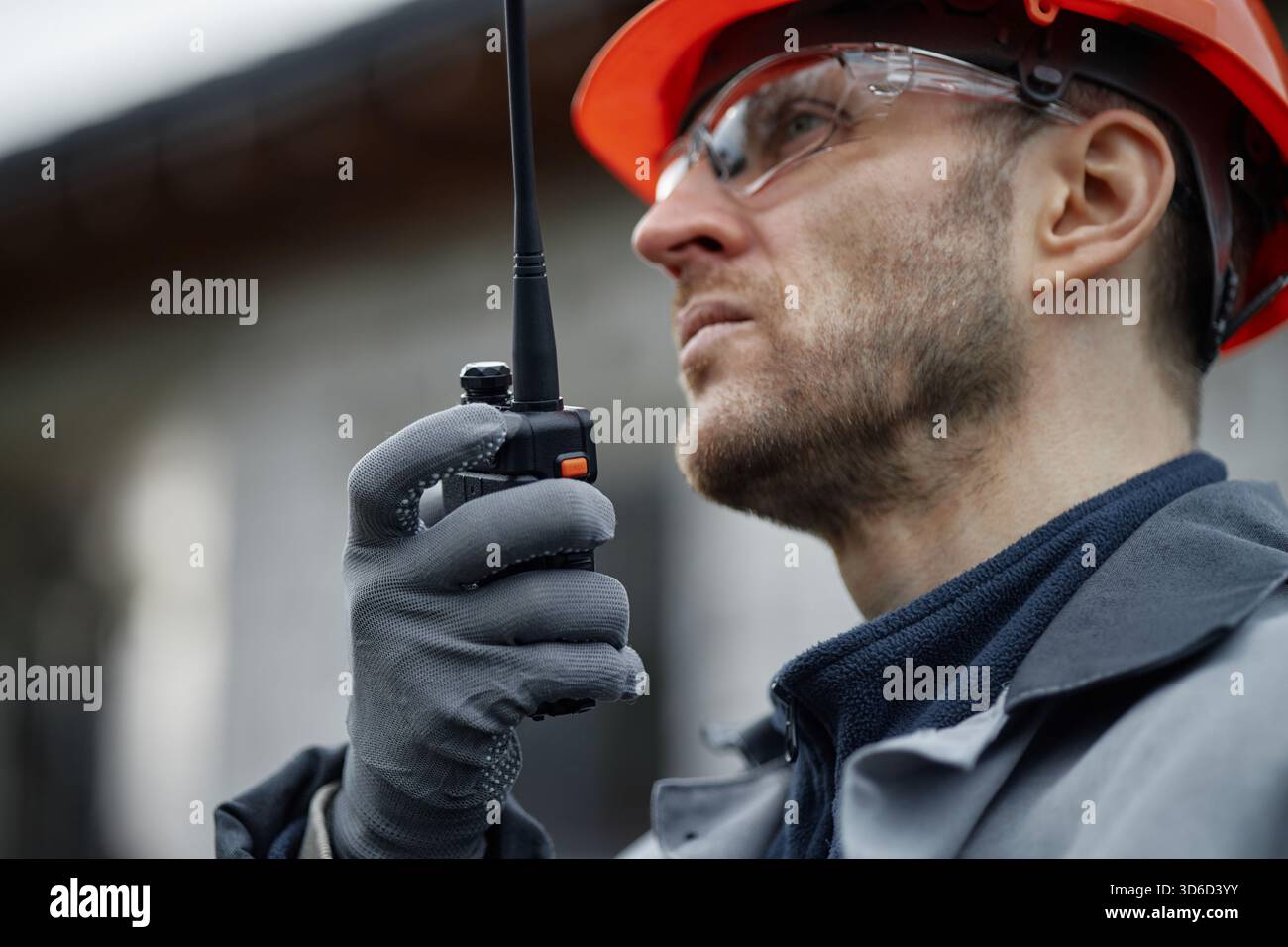Caucasian Middle Aged Man Using Walkie Talkie While Working Outdoors Stock Photo
