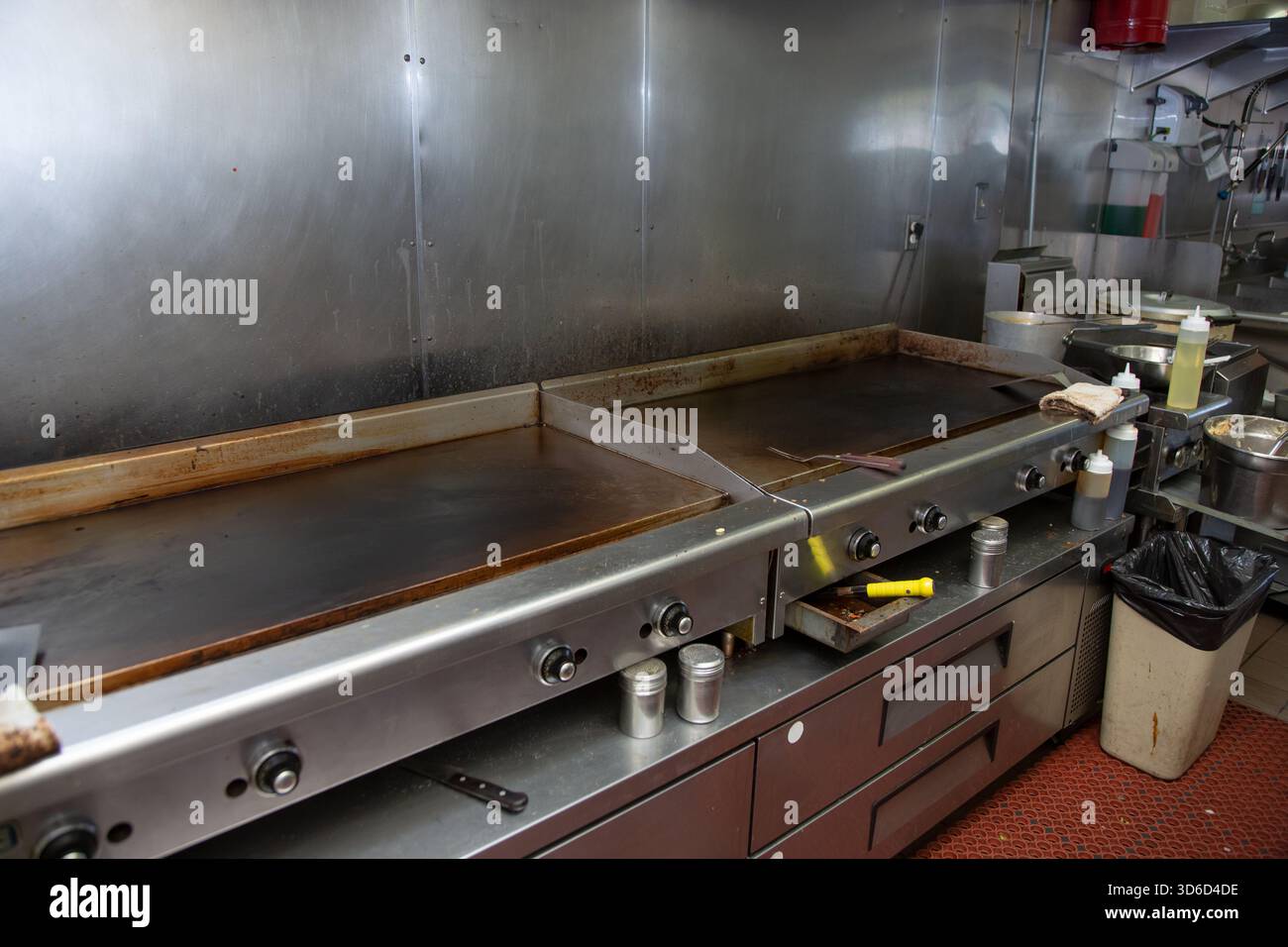 A view of a griddle appliances in a restaurant kitchen setting. Stock Photo