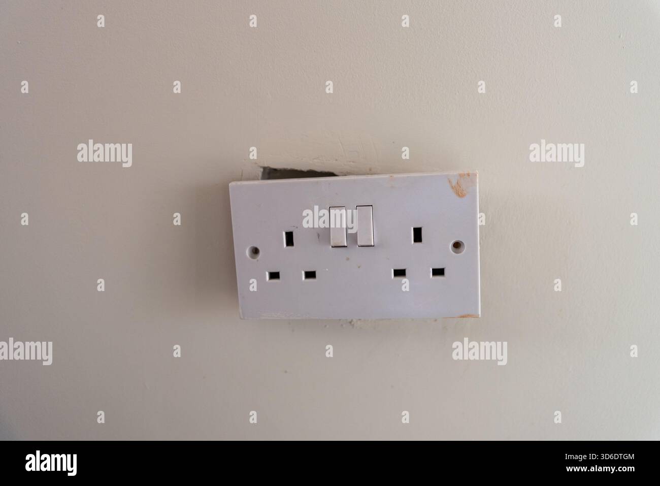 a broken british style double switch electrical socket Stock Photo