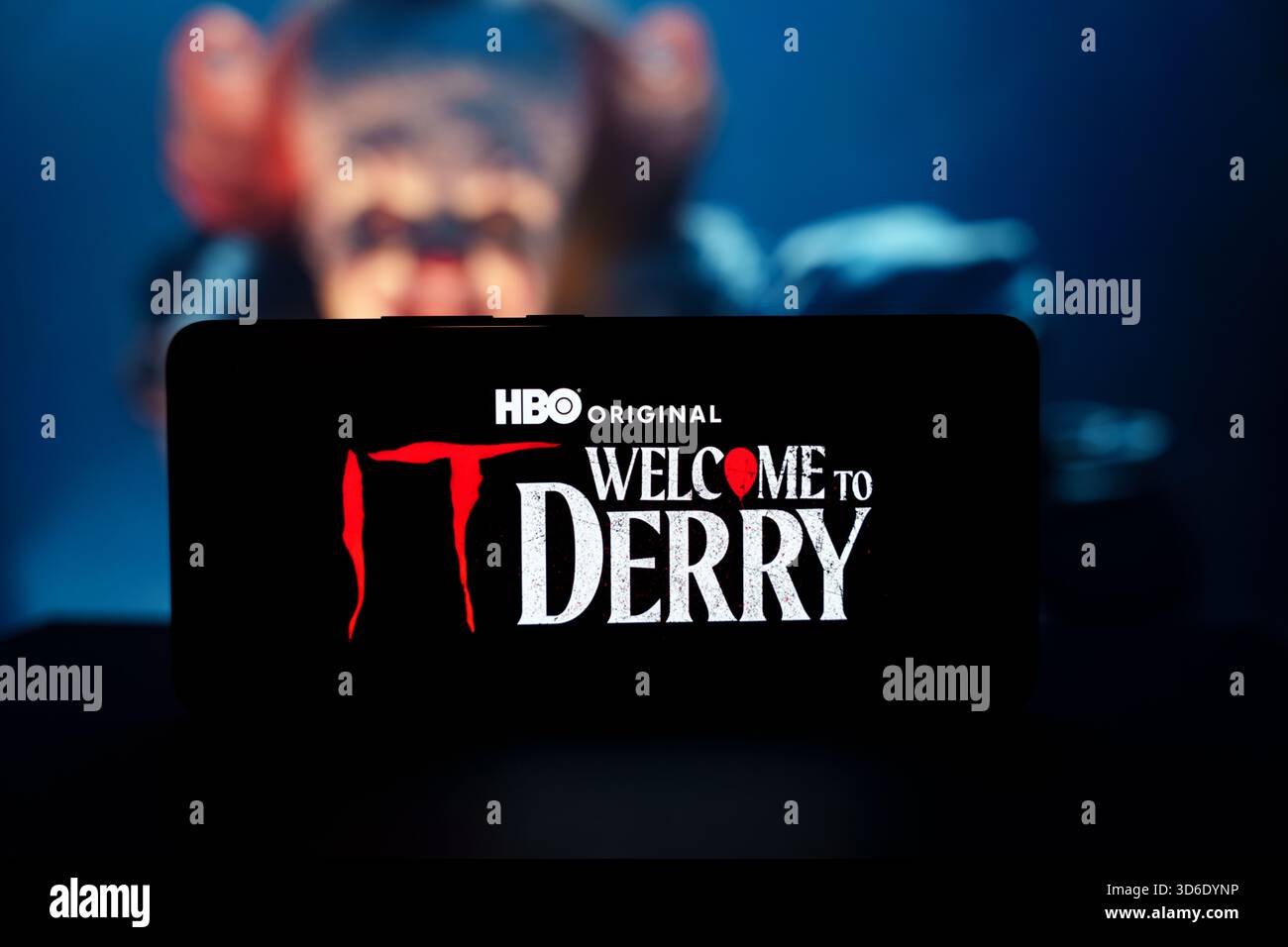 Welcome to Derry HBO series logo on smartphone with clown face background. High quality photo Stock Photo