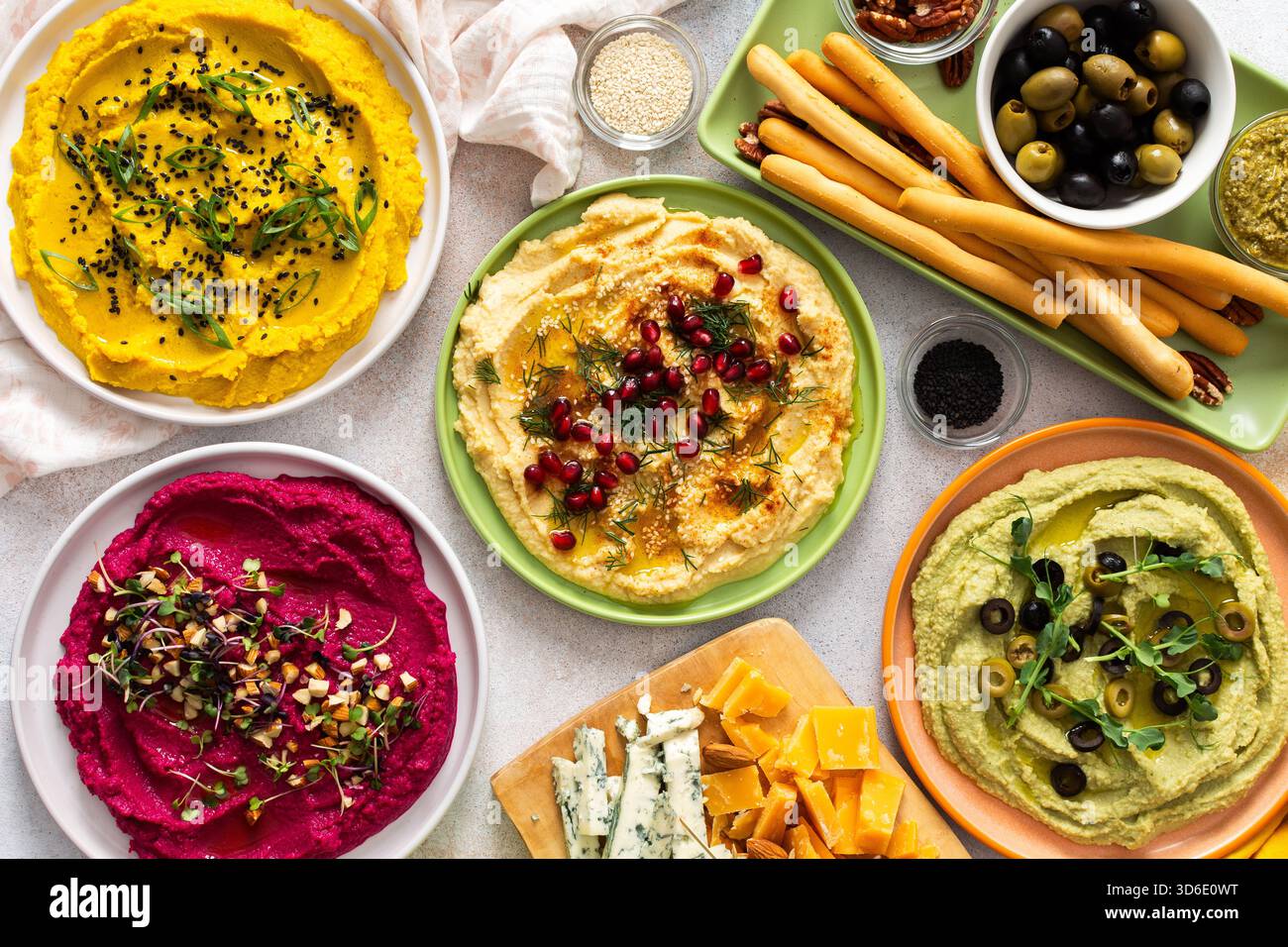 A vibrant spread showcases different types of hummus including classic ...