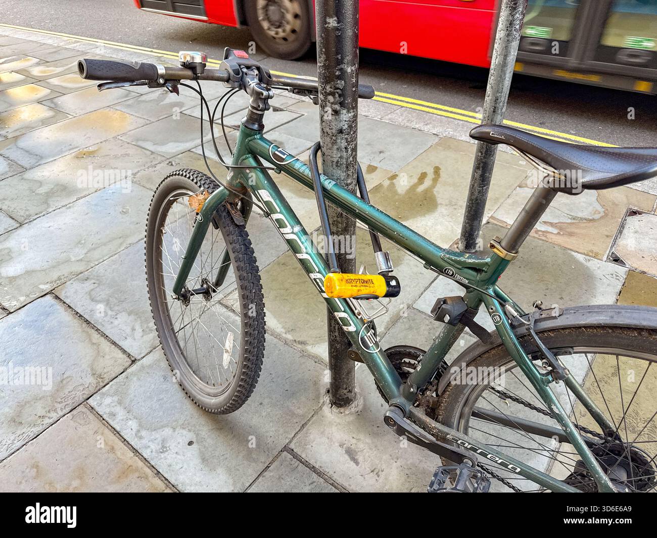London, England, UK - 25 October 2025: Close up view of a bicycle secured to a lamp post in Regent Street in London with a heavy duty cycle lock - Smartphone Captured Stock Image