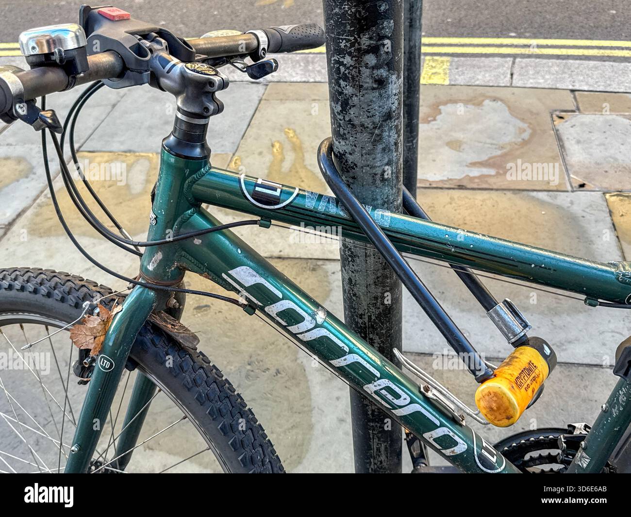 London, England, UK - 25 October 2025: Close up view of a bicycle secured to a lamp post in Regent Street in London with a heavy duty cycle lock - Smartphone Captured Stock Image