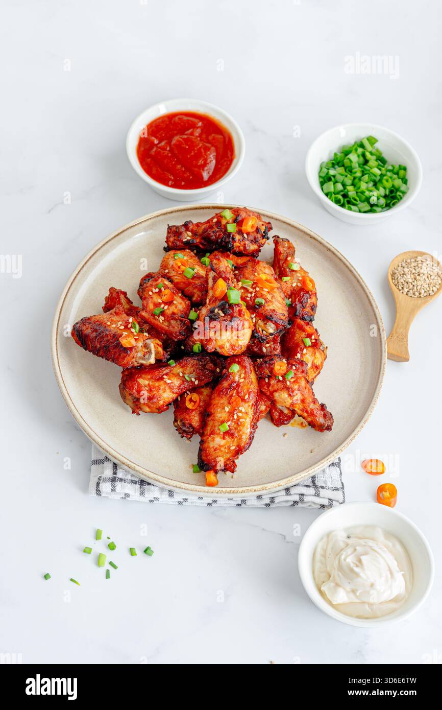Gochujang Chicken Wings with Condiments Top Down Vertical Photo Stock Photo