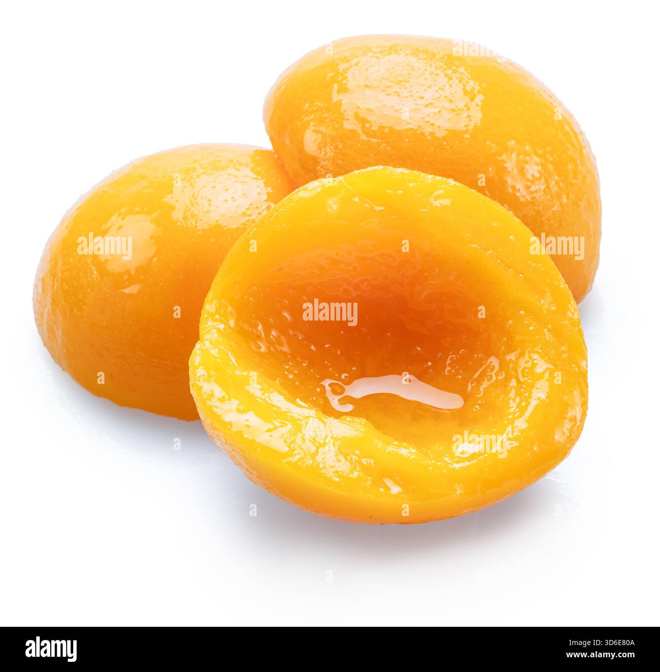 Peeled canned peach halves isolated on white background. File contains clipping paths. Stock Photo