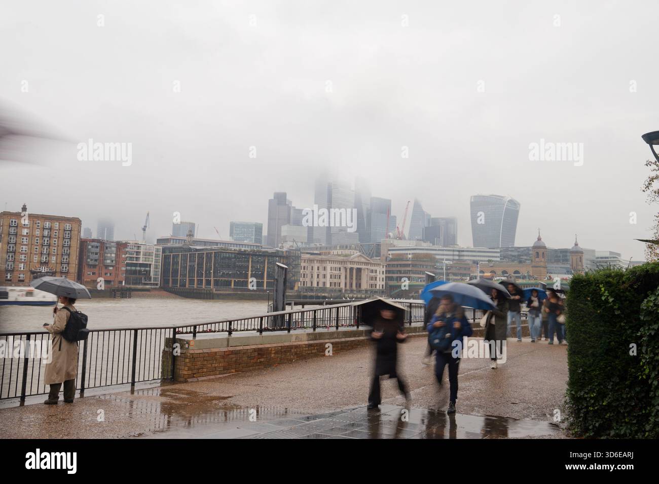 A rain soaked capital city of London on a wet day. Misty and rainy! The offices of the City of London in the background. Financial district Stock Photo