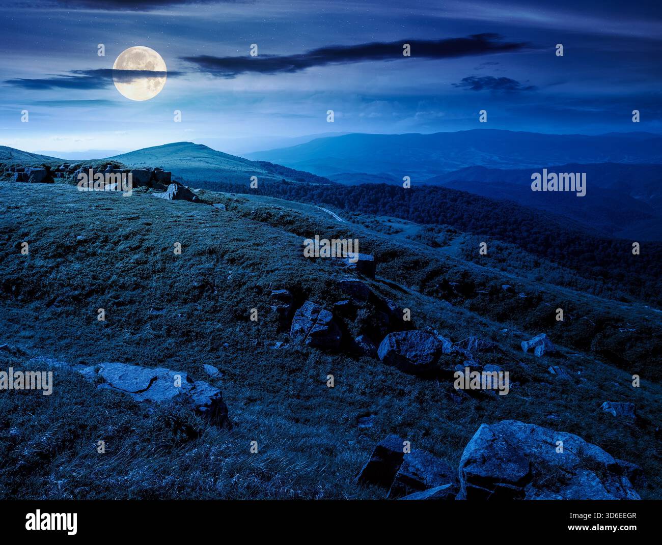 alpine meadows in mountains in summer at night. stones on grassy hills in full moon light. popular travel destination for photo. background for invest Stock Photo