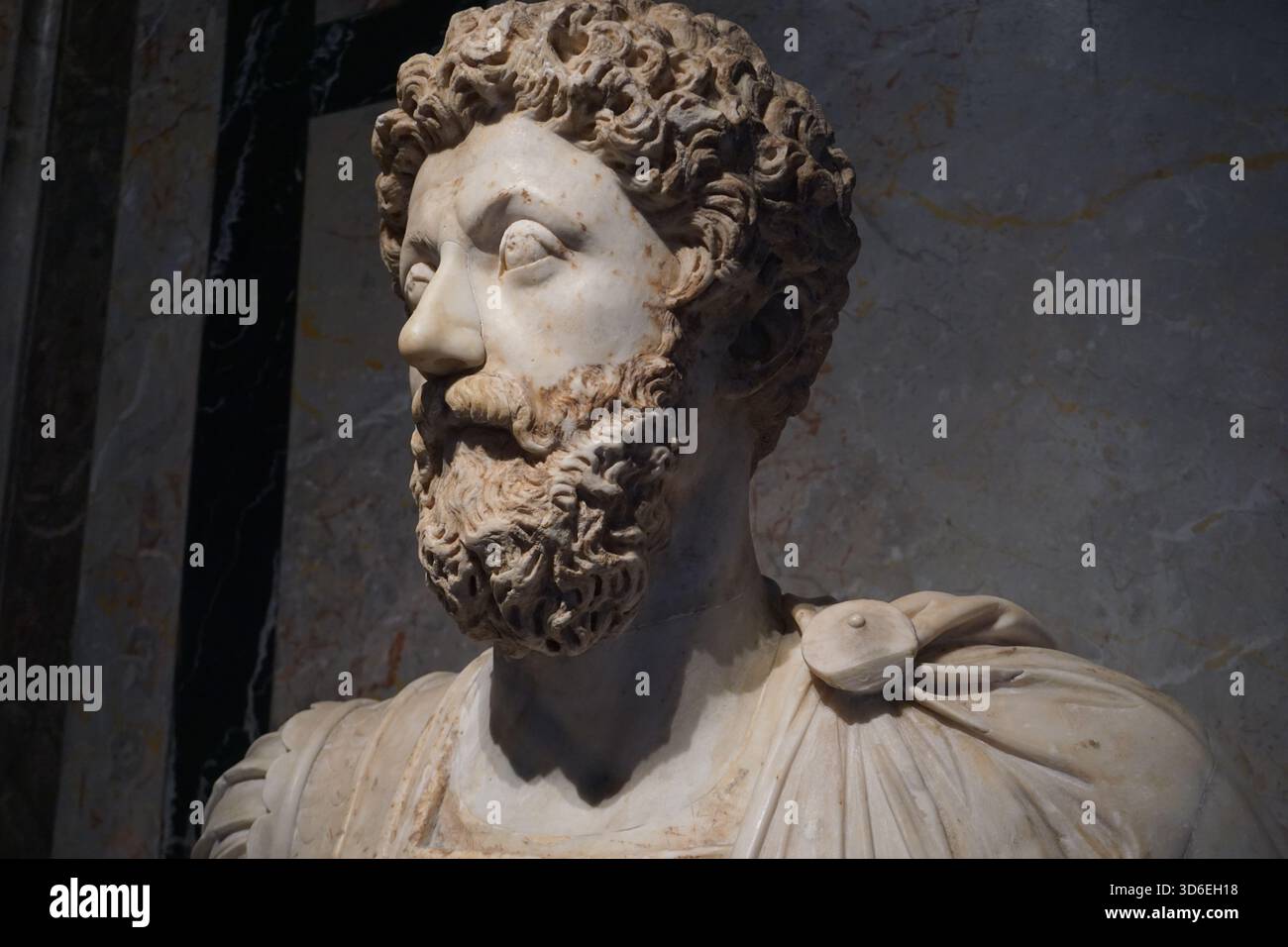 Close up portrait of an ancient marble bust or statue of Roman emperor ...