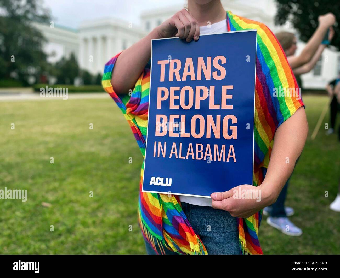 FILE - A person holds up a sign reading, 