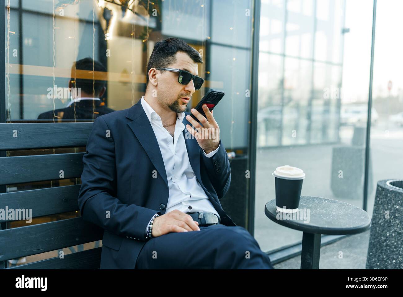 Man wearing sunglasses sits table hi-res stock photography and images ...