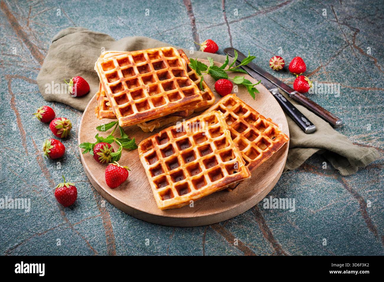 fresh baked homemade Brussels waffles with fresh strawberries on a plate Stock Photo