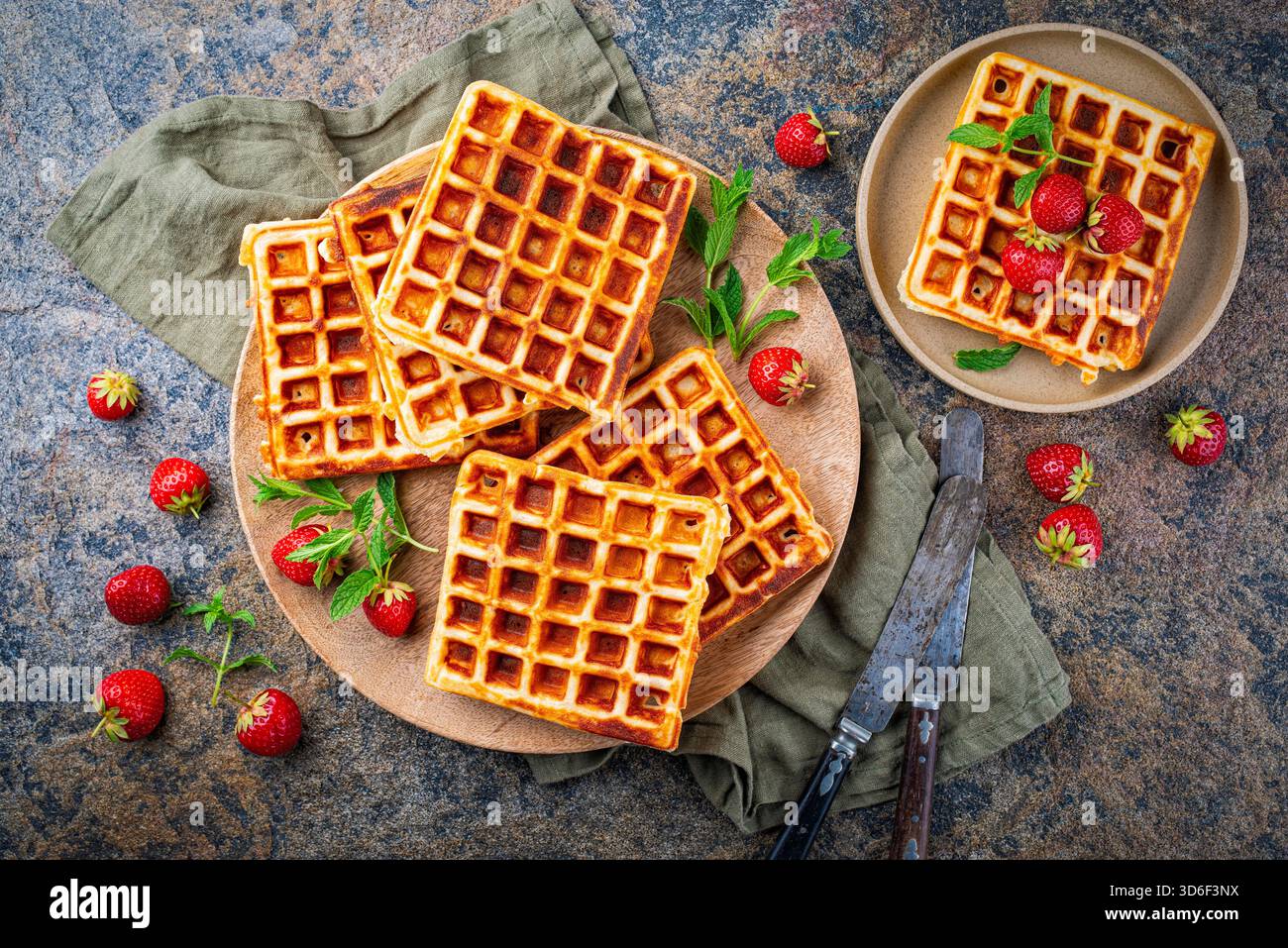 fresh baked homemade Brussels waffles with fresh strawberries on a plate Stock Photo