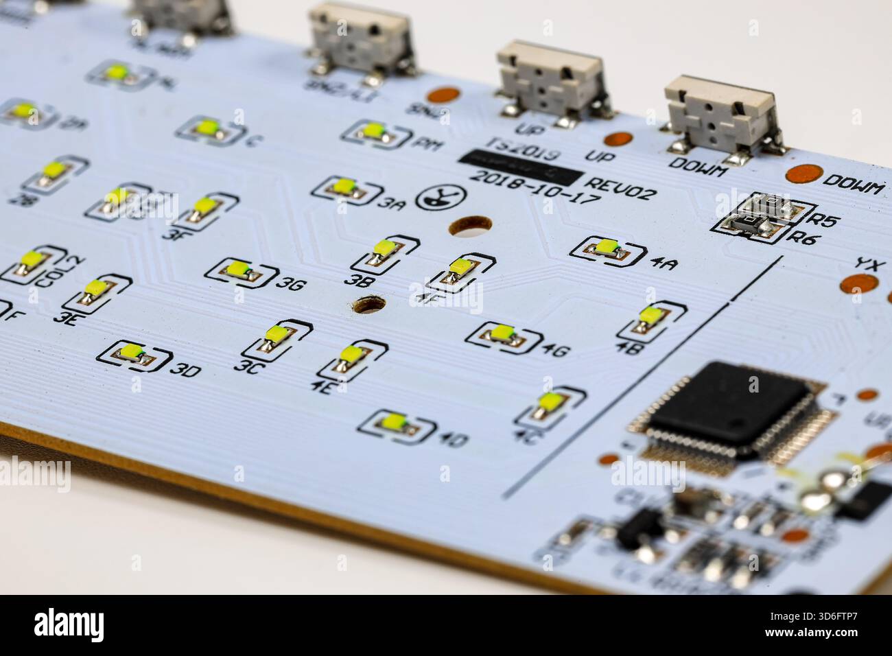 Controller module on LED light module board, electronic circuit panel with surface mount diodes on gray PCB. Stock Photo
