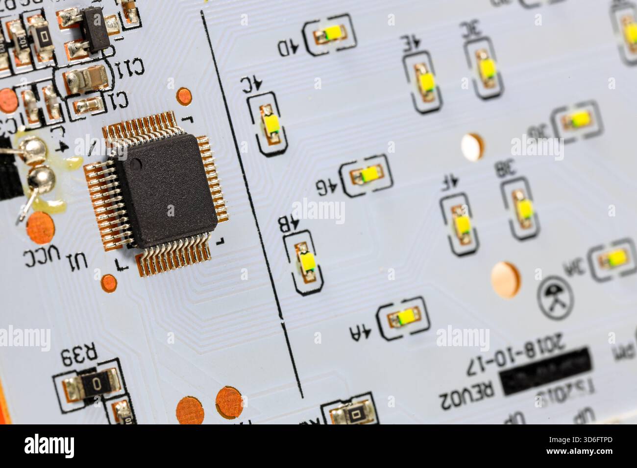 Controller module on LED light module board, electronic circuit panel with surface mount diodes on gray PCB. Stock Photo