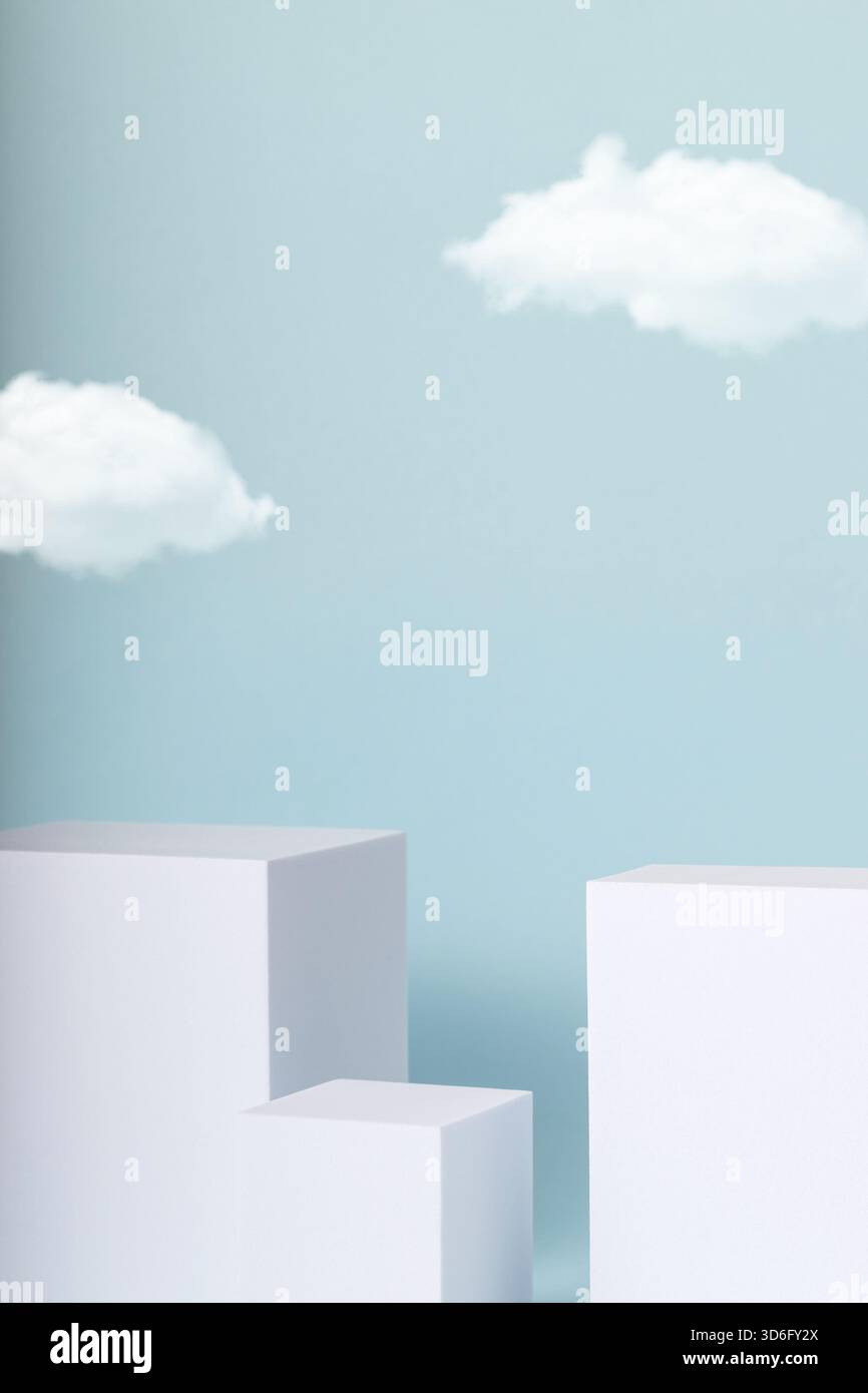 Minimal concept with white cubes and cloud on blue background. Stock Photo