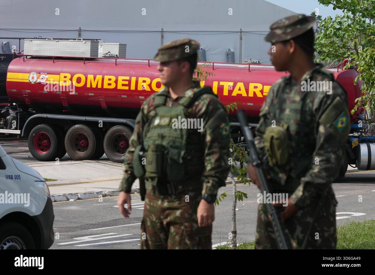 Security personnel stand guard as a fire truck arrives to the venue ...