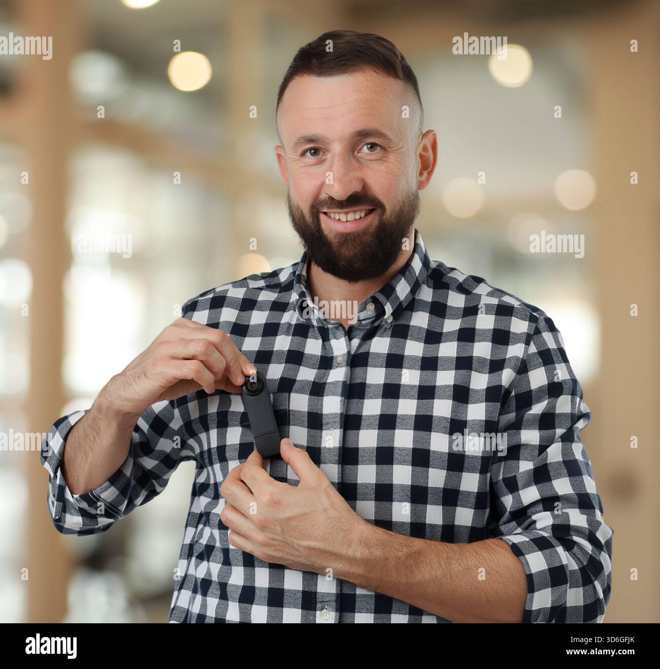 Man with hidden spy camera in office Stock Photo