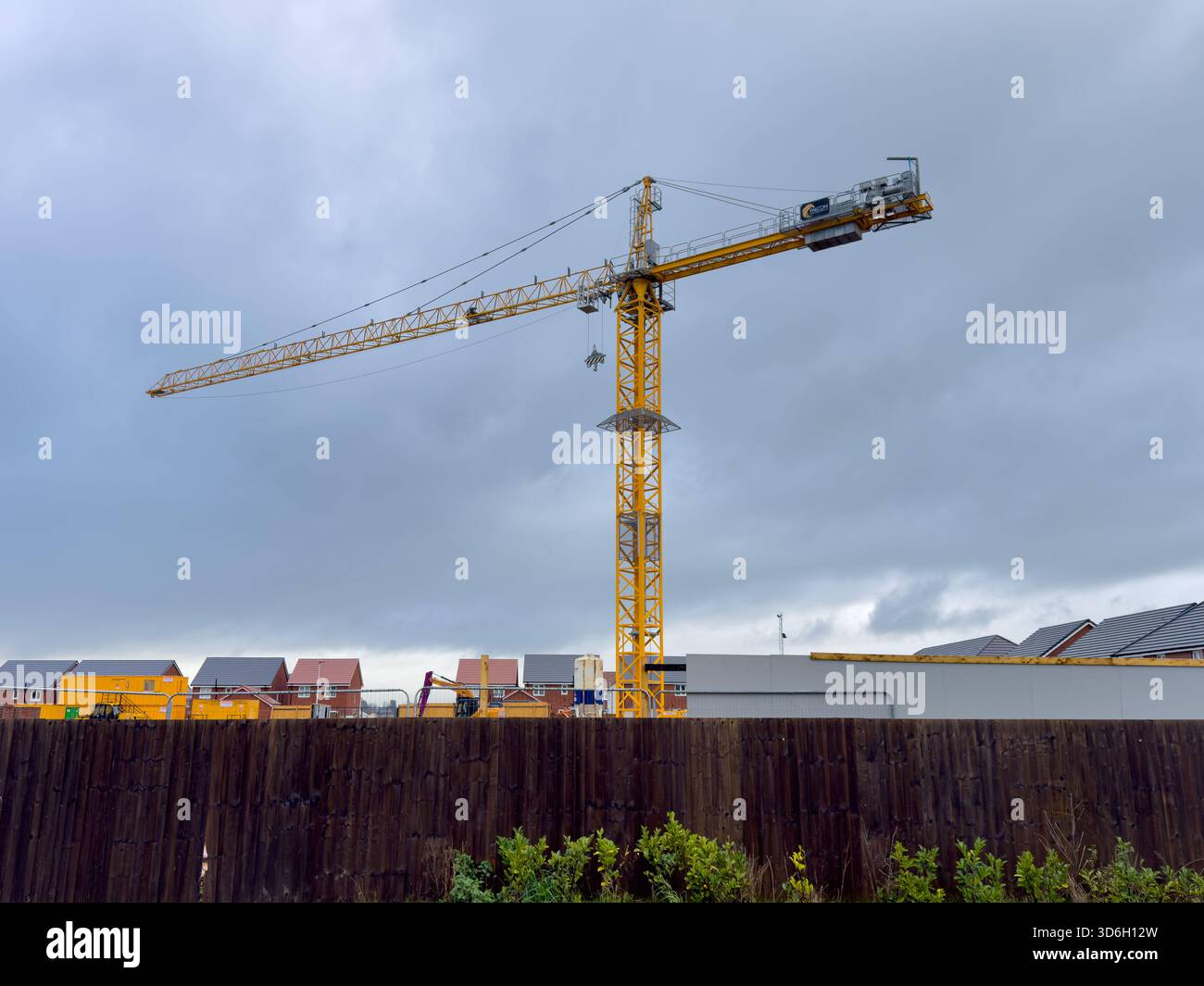 Yellow crane at a new build housing  construction site in Maghull Sefton UK - Smartphone Captured Stock Image