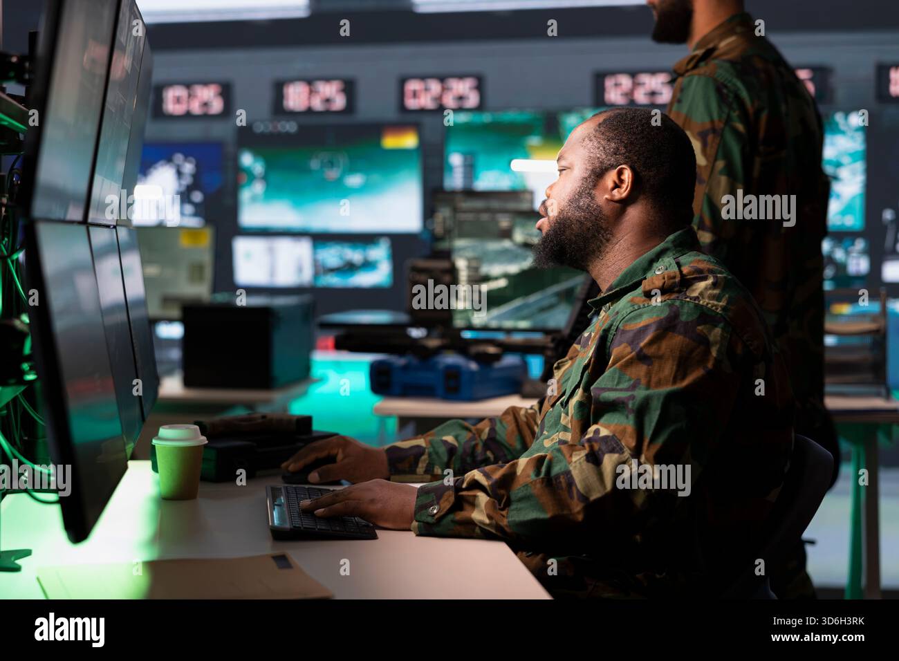 Army operative analyzing surveillance data during international war ...