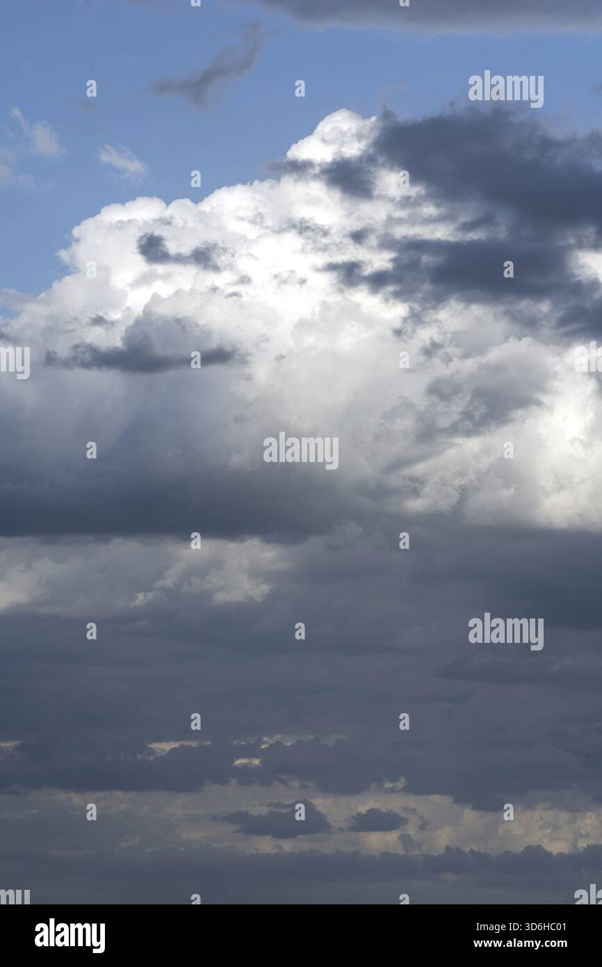 Sky with white and dark blue clouds. Dramatic cloudy sky background. Moody Cloudscape Stock Photo