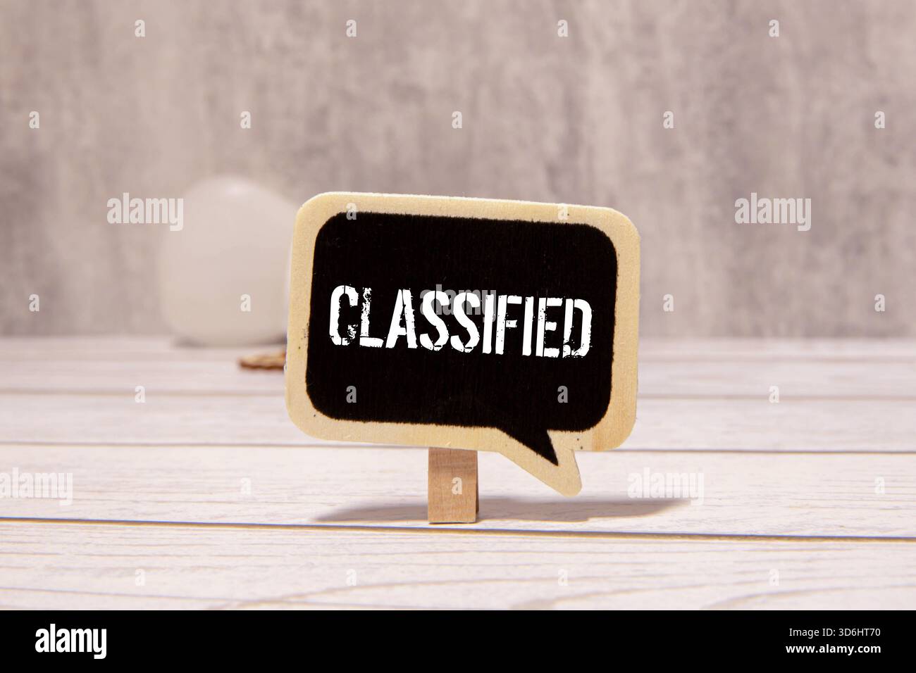 The word confidential appearing behind torn paper Stock Photo