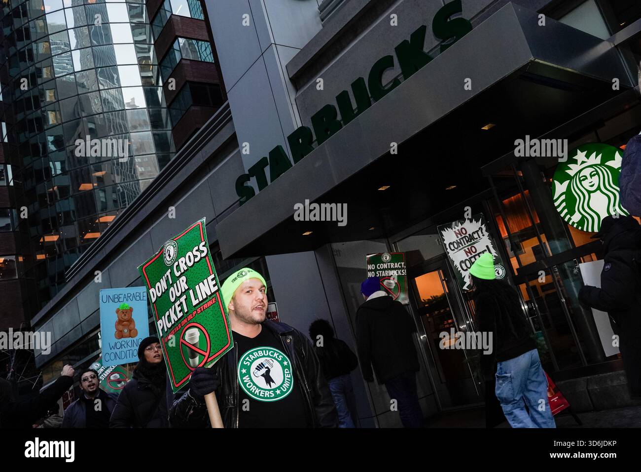 Starbucks baristas and employees picket outside a Starbucks storefront(01)