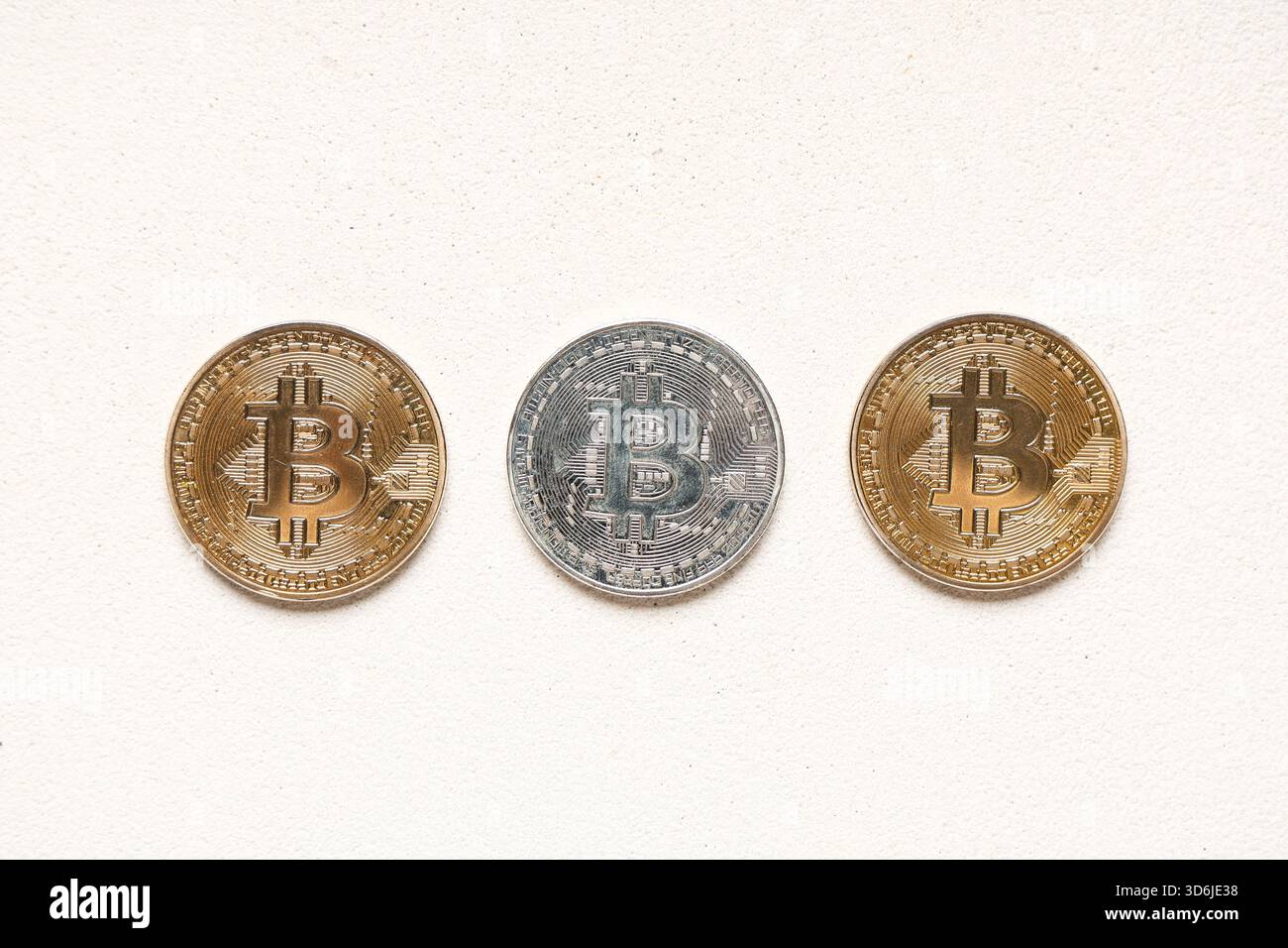 Different bitcoins on white grunge background Stock Photo