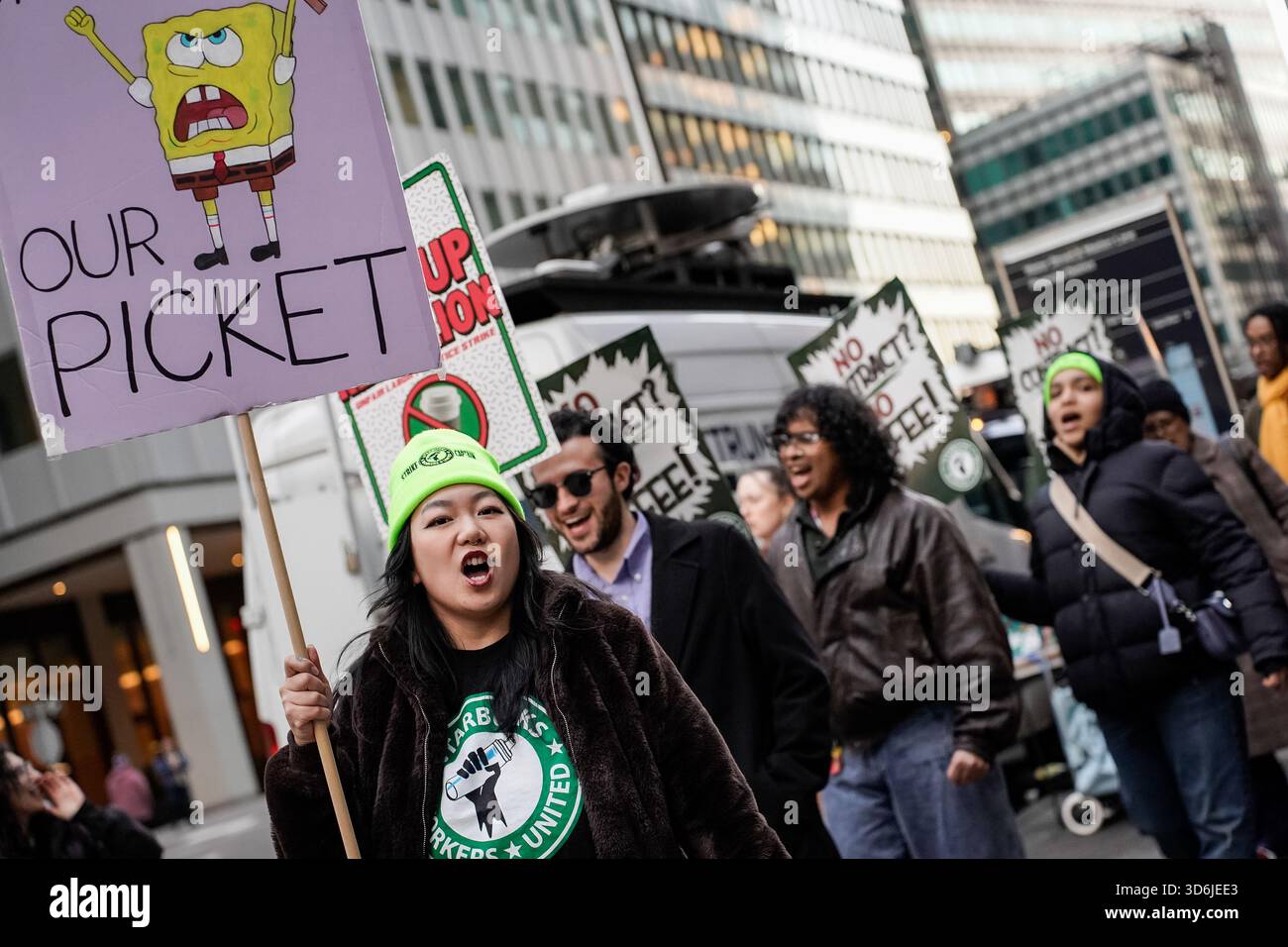 A Starbuck employees chants while picketing outside a Starbucks