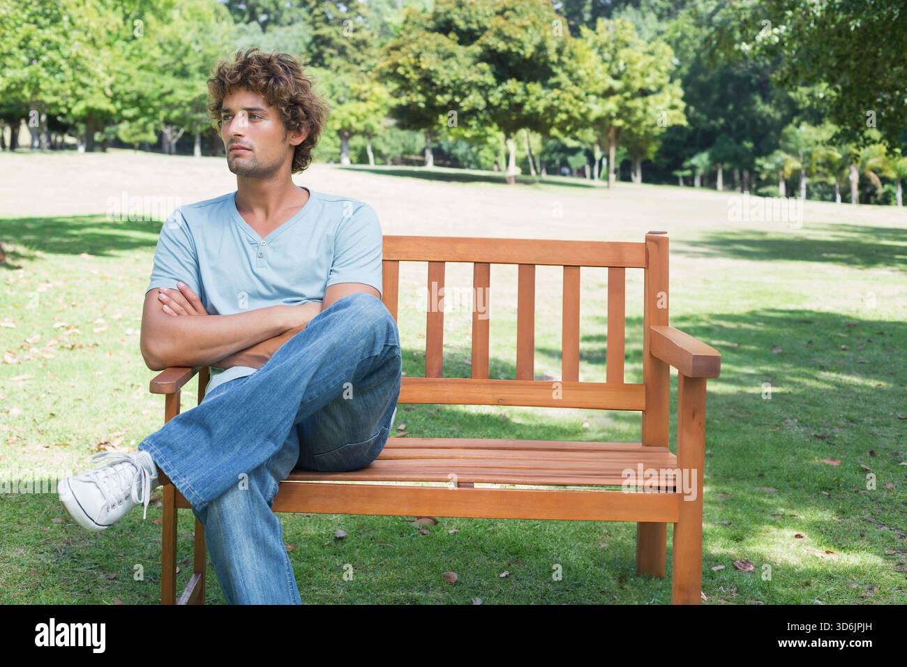 Crossed legs wearing blue jeans hi-res stock photography and images - Alamy