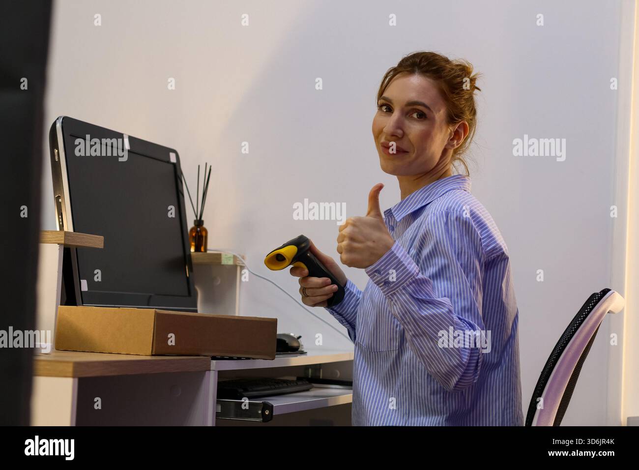 Employee in order issuance area displays positive sign holding scanning ...