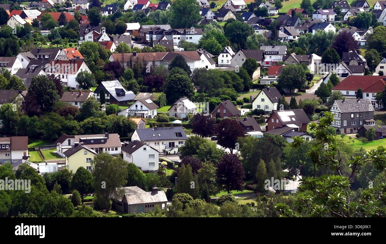 Elevated view mapping a landscape of multiple detached houses nestled amongst lush trees, showing residential expansion Stock Photo