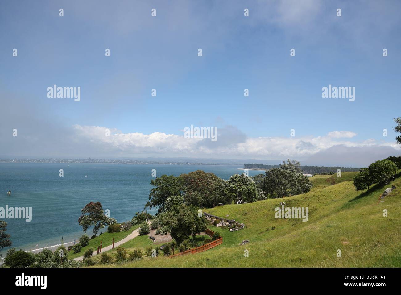 Coastal Hillside Overlooking Calm Blue Ocean Bay Stock Photo - Alamy