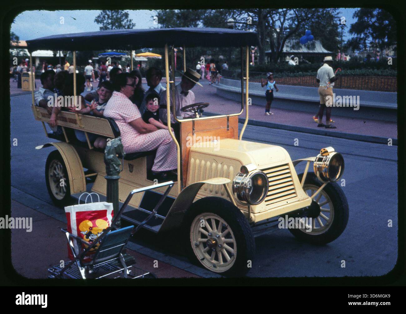 A family rides in a vintage car on Main Street at Walt Disney World ...