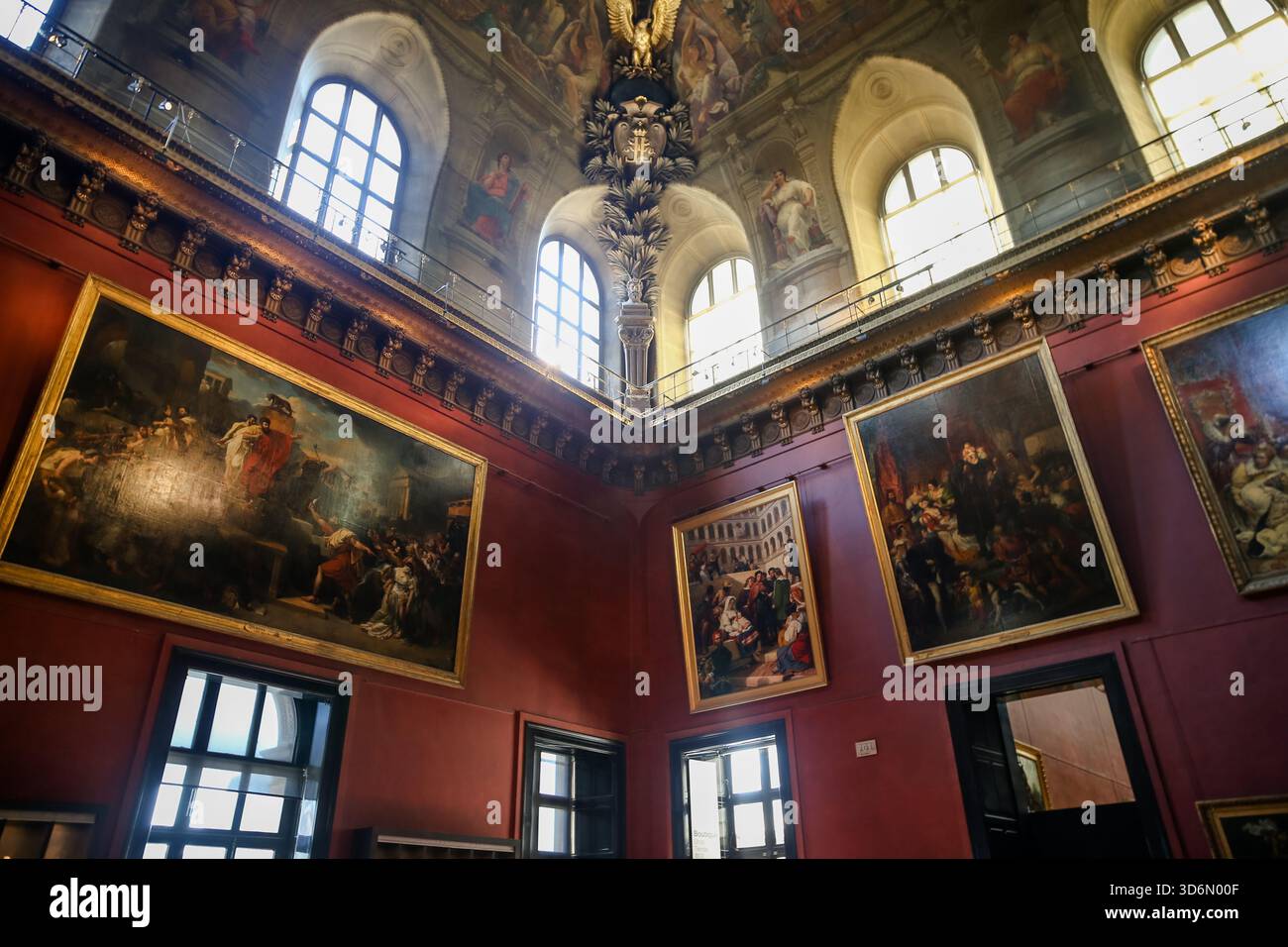 Visitors inside the Louvre Museum atrium in Paris walking beneath the ...