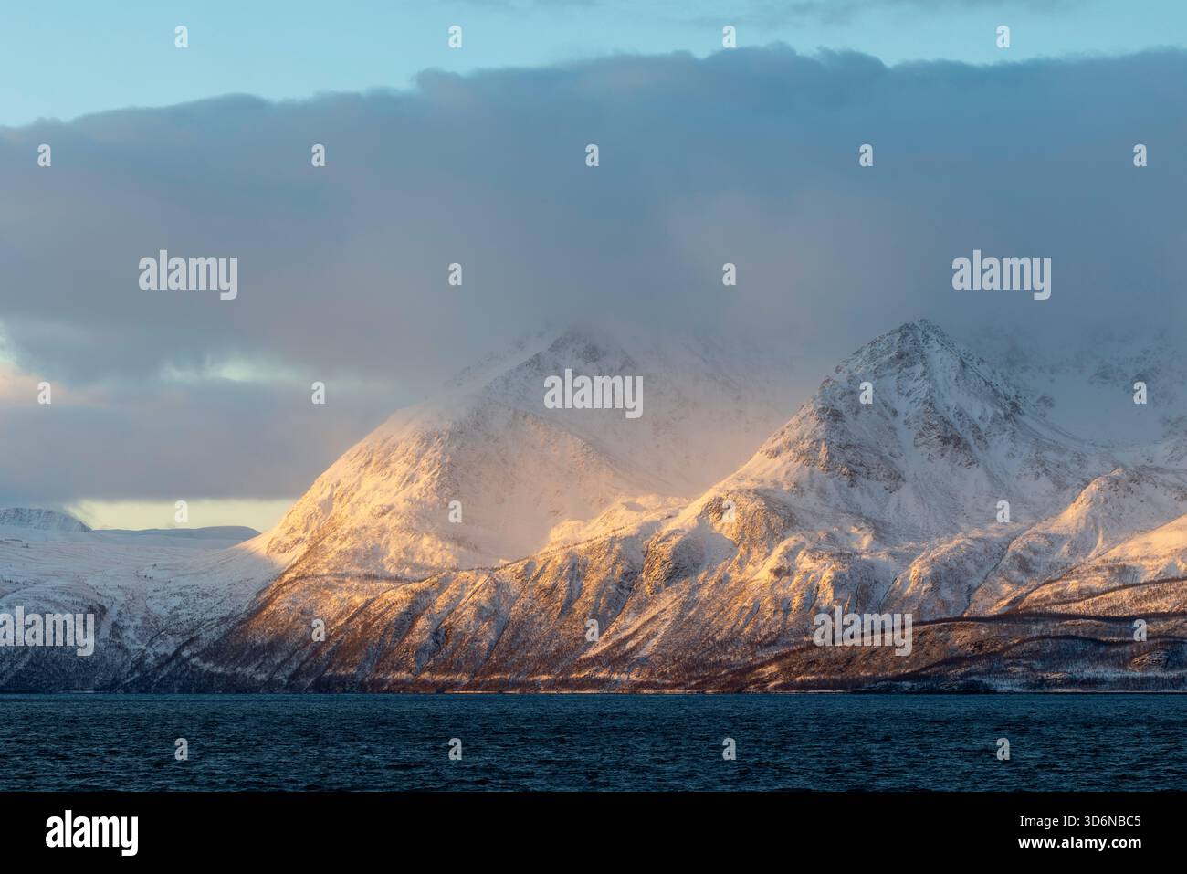 Golden Sunlight Breaking Through Arctic Clouds Stock Photo